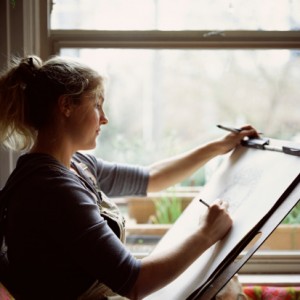 Woman drawing on easel